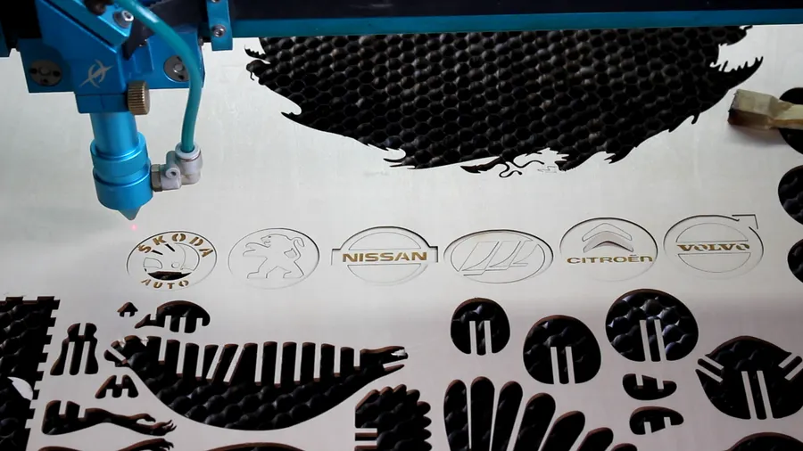 laser cutting the key pendants.webp
