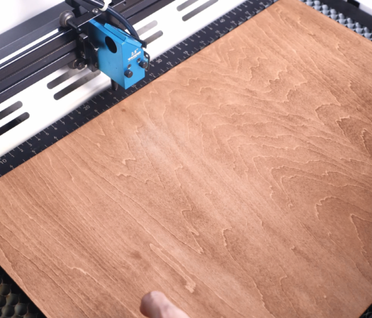 put the wood on the laser bed.png